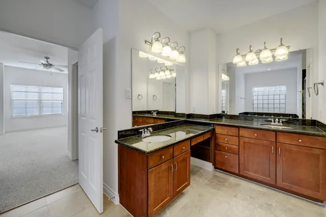 a kitchen with granite countertop a sink stove and cabinets