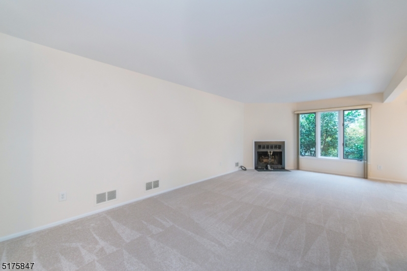 71 Patriots Road Morris Plains, NJ 07950 - Photo 4 of 18 a view of an empty room with a fireplace and a window