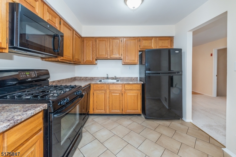 71 Patriots Road Morris Plains, NJ 07950 - Photo 9 of 18 a kitchen with a stove a refrigerator and a microwave