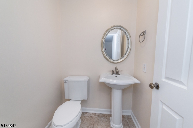 71 Patriots Road Morris Plains, NJ 07950 - Photo 10 of 18 a bathroom with a toilet a sink and a mirror
