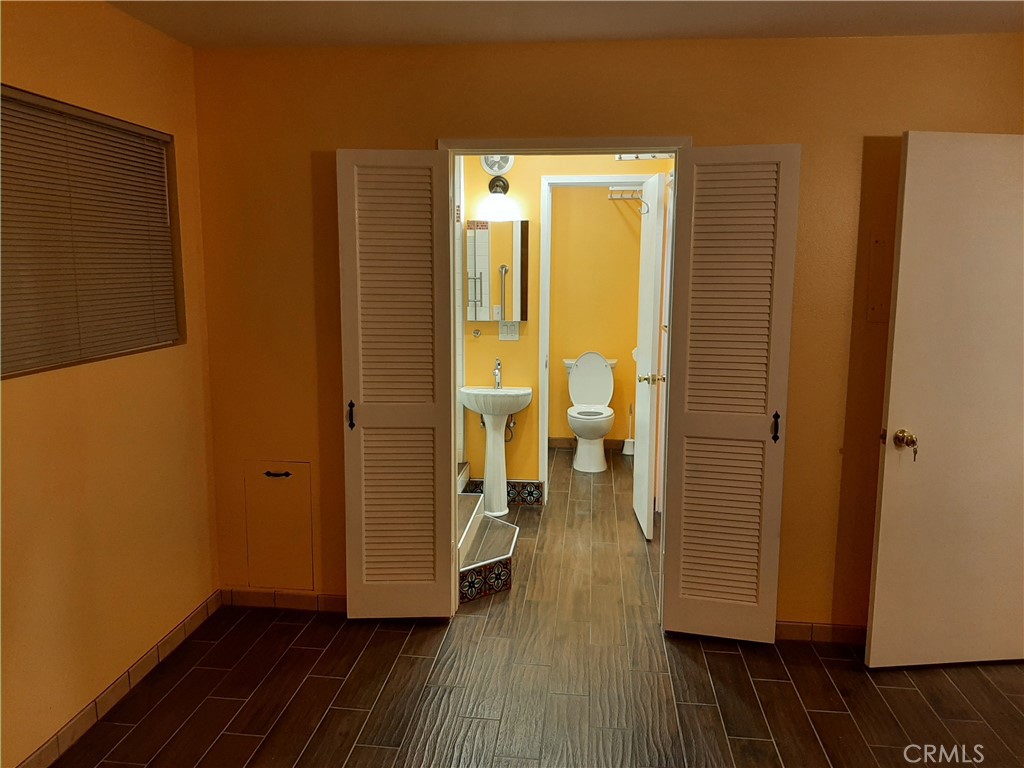 12592 Montecito Road, Unit 9 Seal Beach, CA 90740 - Photo 9 of 16 a view of a room with wooden floor and a view of bedroom