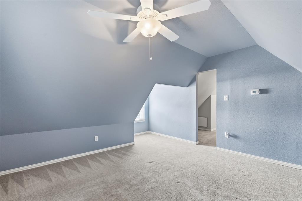 9121 6th Street Frisco, TX 75033 - Photo 18 of 27 wooden floor in an empty room with a chandelier fan