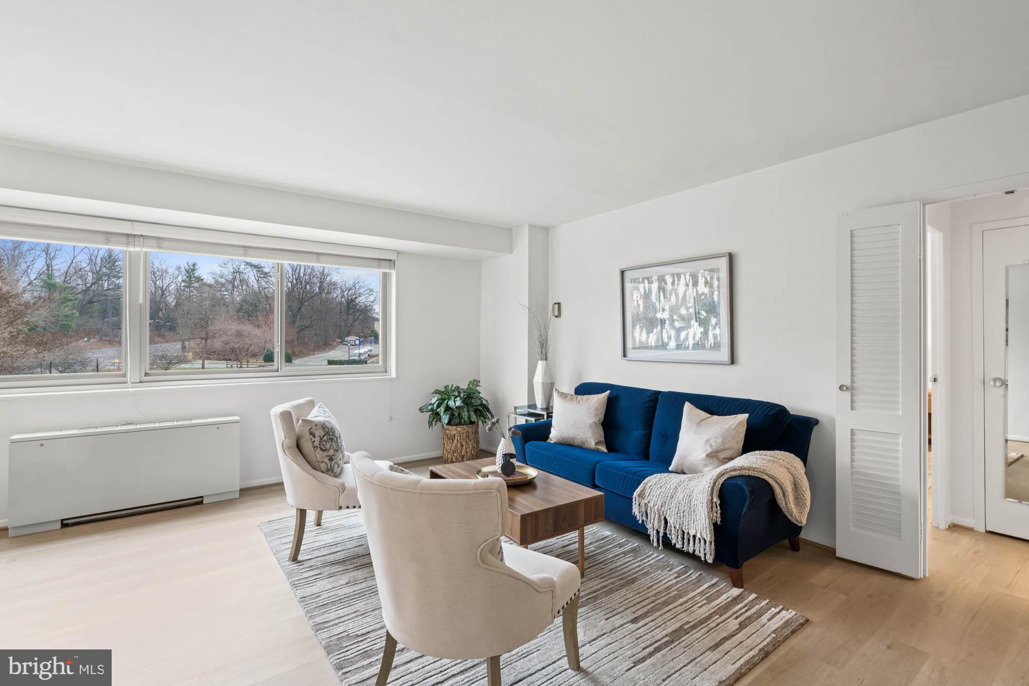 5100 Dorset Avenue, Unit 111 Chevy Chase, MD 20815 - Photo 11 of 38 a living room with furniture and a large window