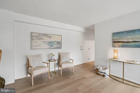 a living room with furniture a table and a potted plant