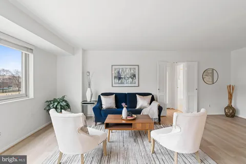a living room with furniture a table and chair