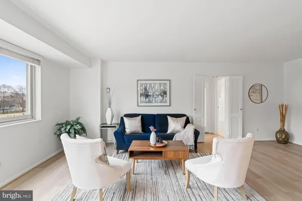 a living room with furniture a table and chair