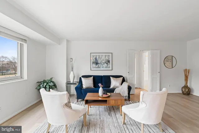 a living room with furniture a table and chair