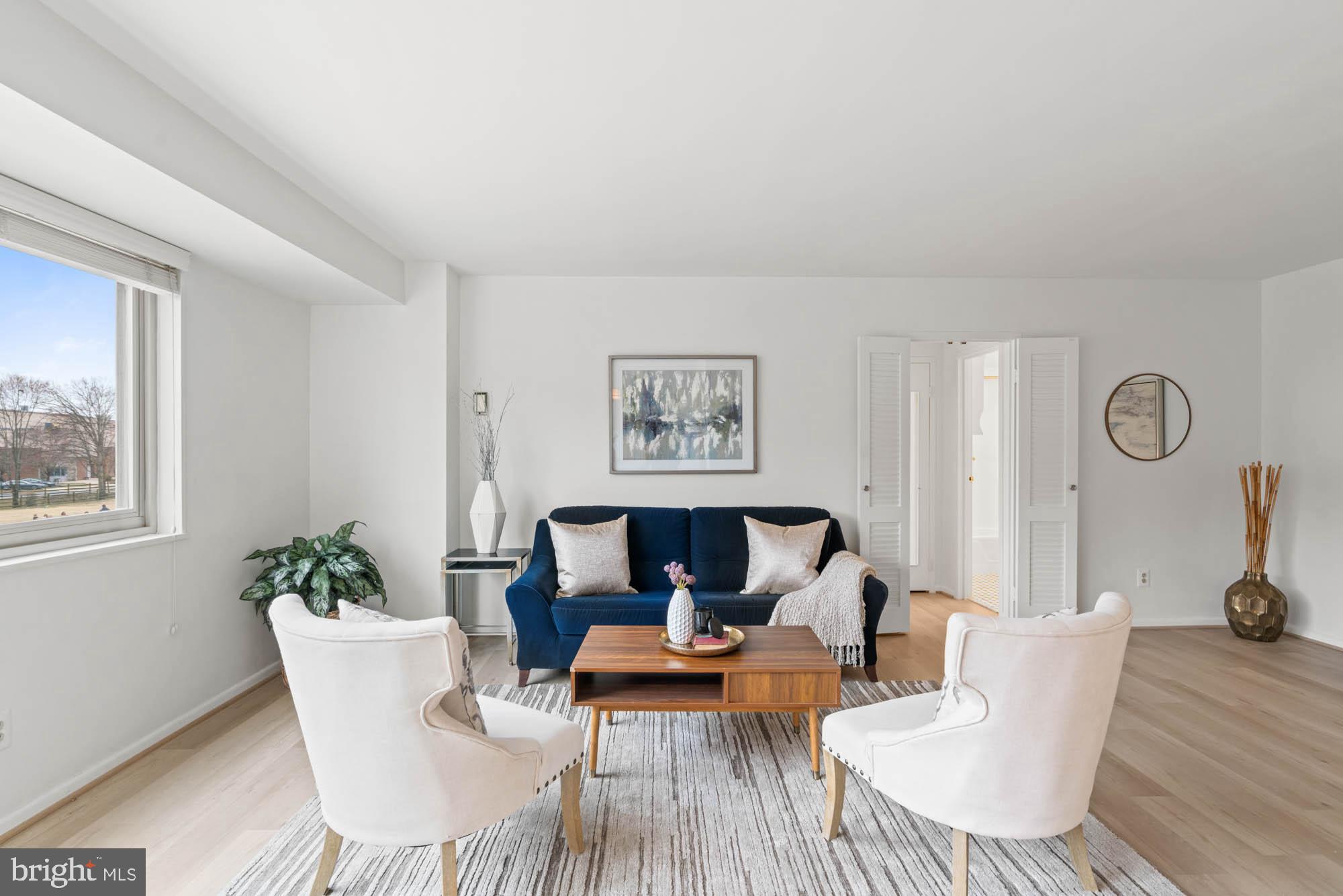 5100 Dorset Avenue, Unit 111 Chevy Chase, MD 20815 - Photo 17 of 38 a living room with furniture a table and a potted plant