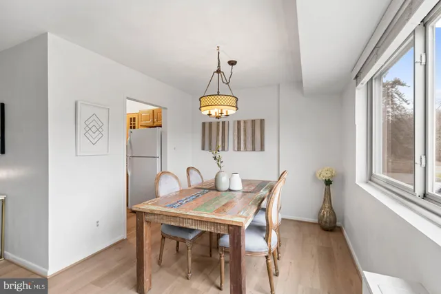 a view of a dining room with furniture chandelier and wooden floor