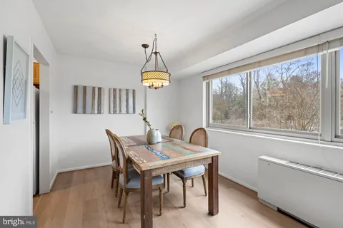 a dining room with furniture a window and a chandelier
