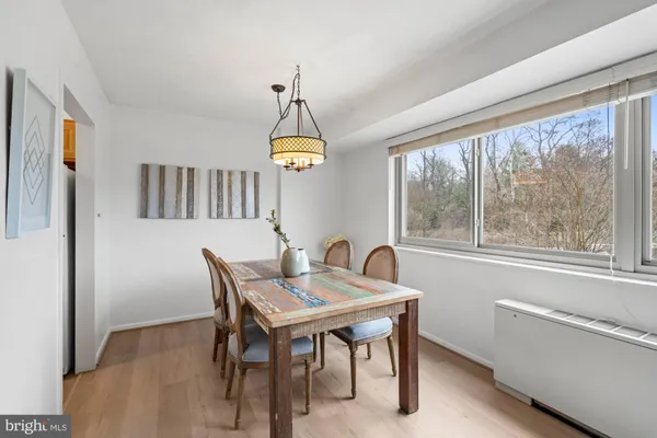 a dining room with furniture a window and a chandelier