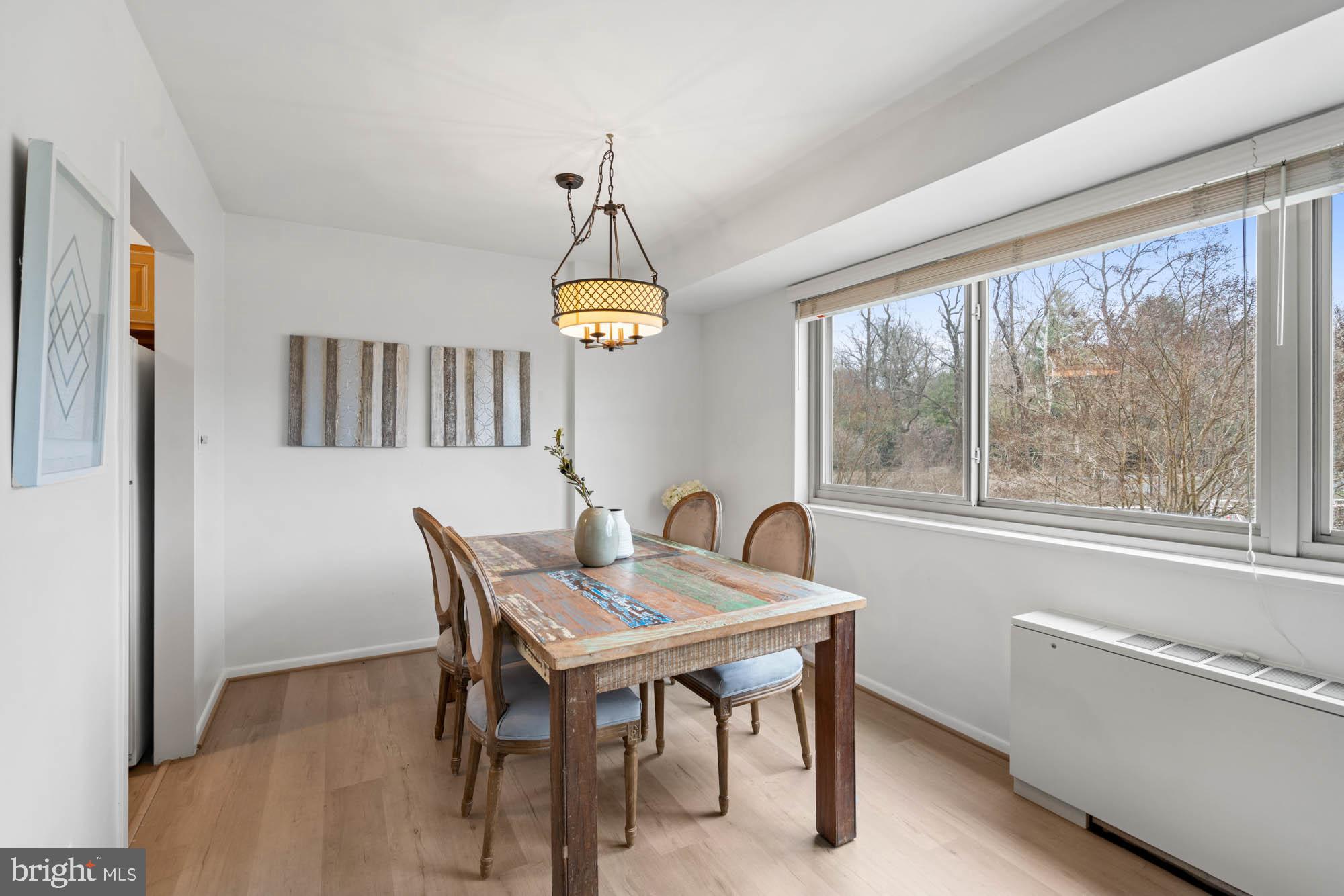 5100 Dorset Avenue, Unit 111 Chevy Chase, MD 20815 - Photo 21 of 38 a view of a dining room with furniture window and wooden floor