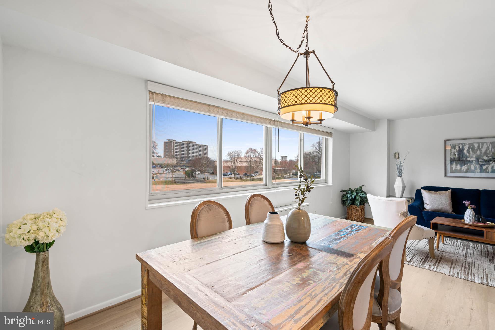 5100 Dorset Avenue, Unit 111 Chevy Chase, MD 20815 - Photo 23 of 38 a dining room with furniture a window and a chandelier