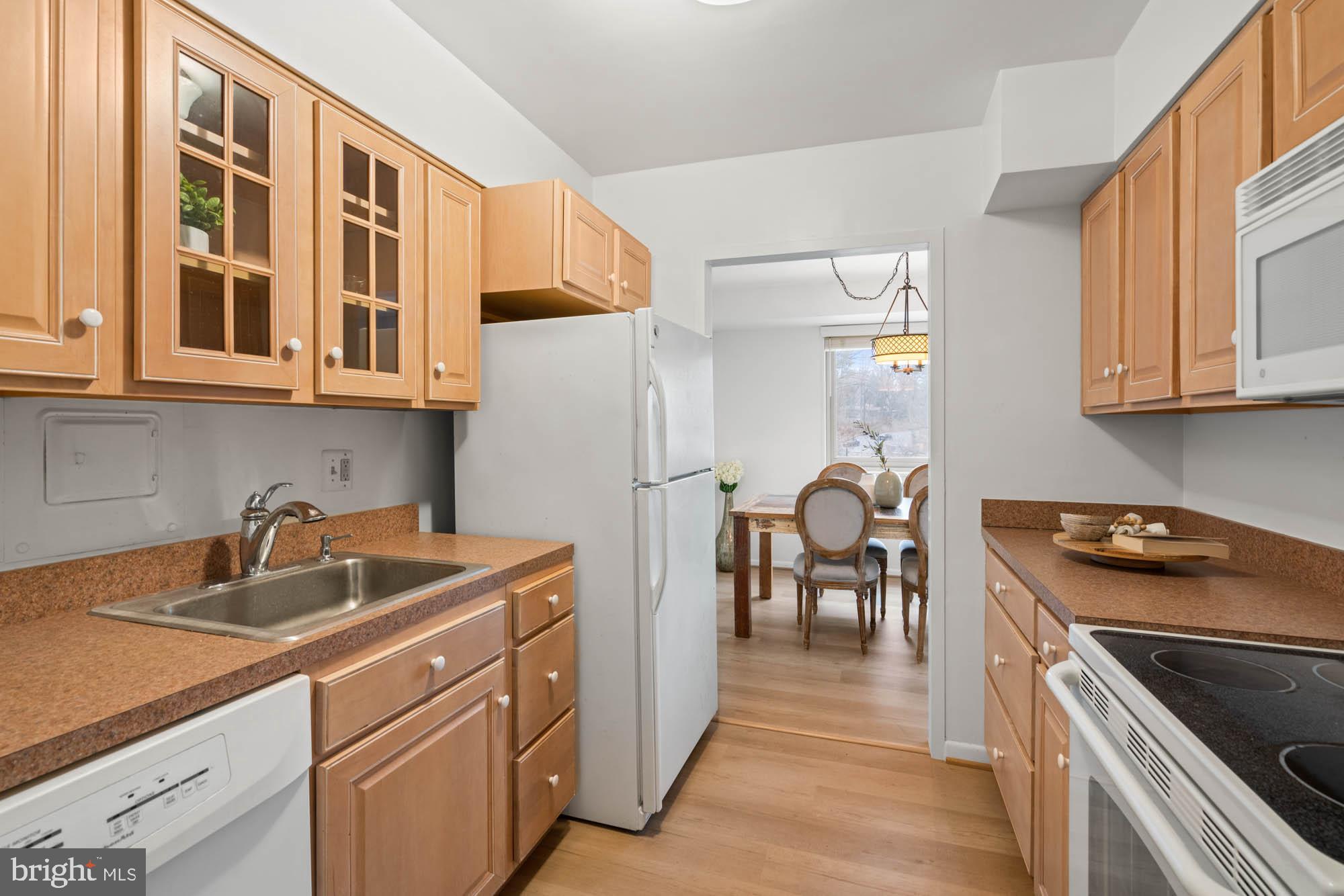 5100 Dorset Avenue, Unit 111 Chevy Chase, MD 20815 - Photo 25 of 38 a kitchen that has a cabinets and a stove top oven