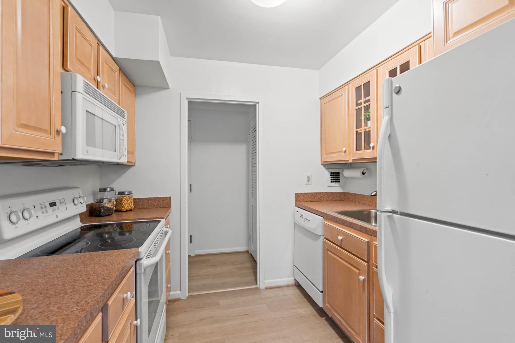 5100 Dorset Avenue, Unit 111 Chevy Chase, MD 20815 - Photo 30 of 38 a kitchen with stainless steel appliances granite countertop a stove and a refrigerator