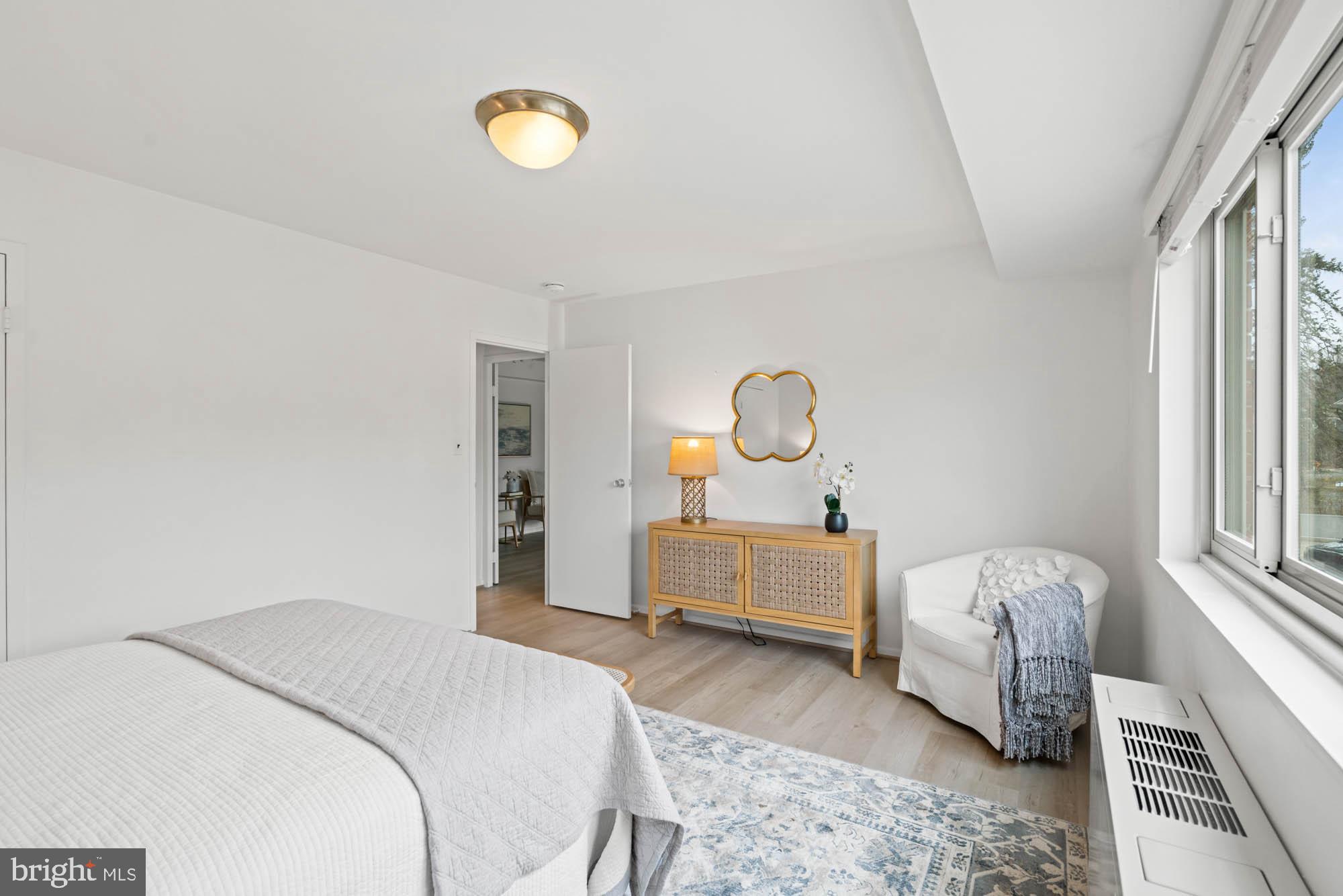 5100 Dorset Avenue, Unit 111 Chevy Chase, MD 20815 - Photo 36 of 38 a bedroom with a bed and a chandelier