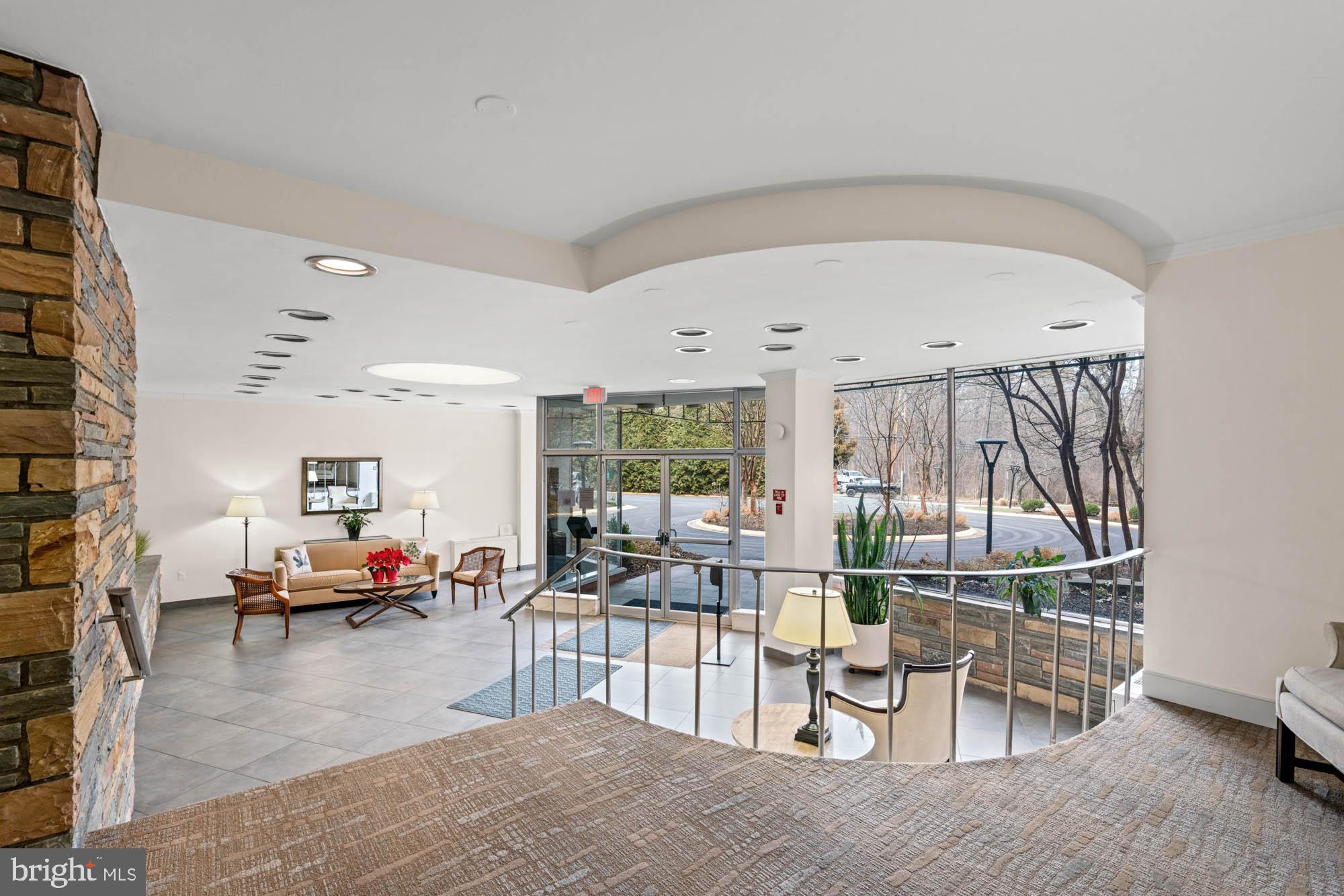 5100 Dorset Avenue, Unit 111 Chevy Chase, MD 20815 - Photo 7 of 38 a living room with furniture a flat screen tv and a large window