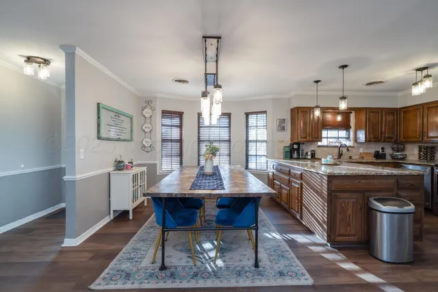 a kitchen with refrigerator dining table and chairs