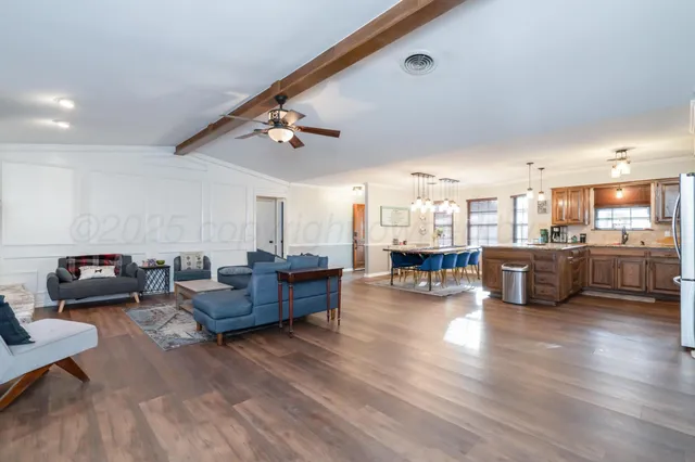 a living room with furniture and kitchen view
