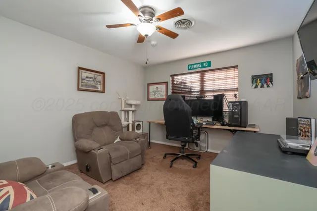 a view of a livingroom with workspace and a couch