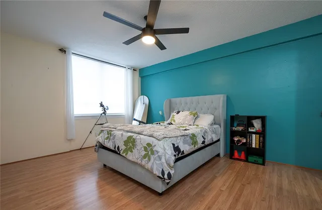 a bed sitting in a bedroom next to a window