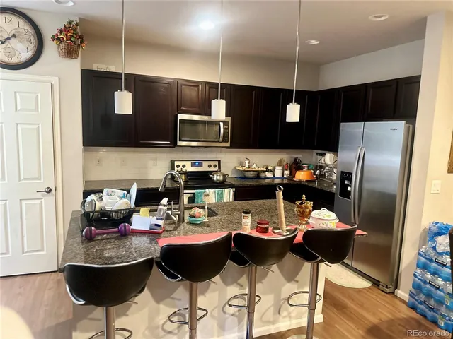 a kitchen with a dining table and chairs