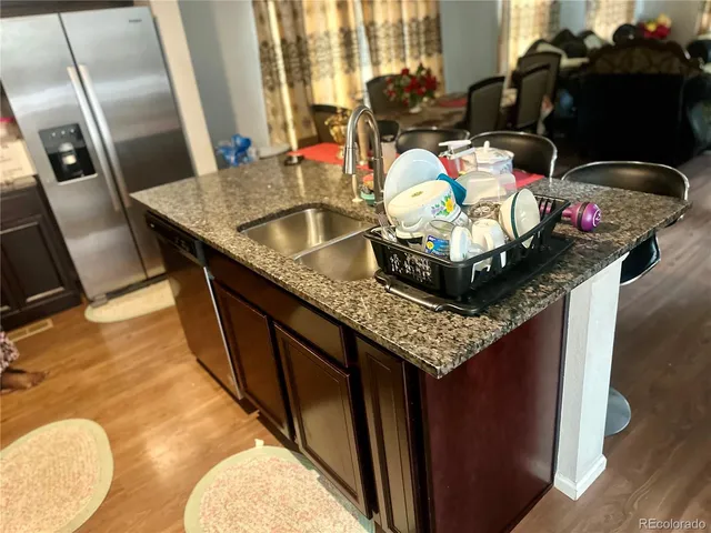 a bathroom with a granite countertop sink a mirror and vanity