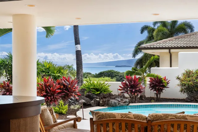 a view of a yard with a table and chair and potted plants