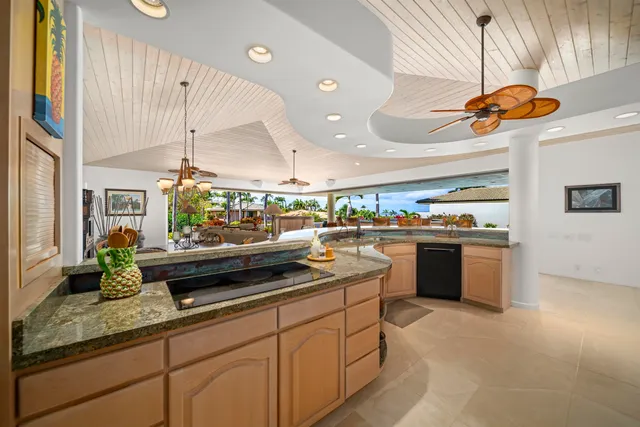 a living room with furniture and kitchen view