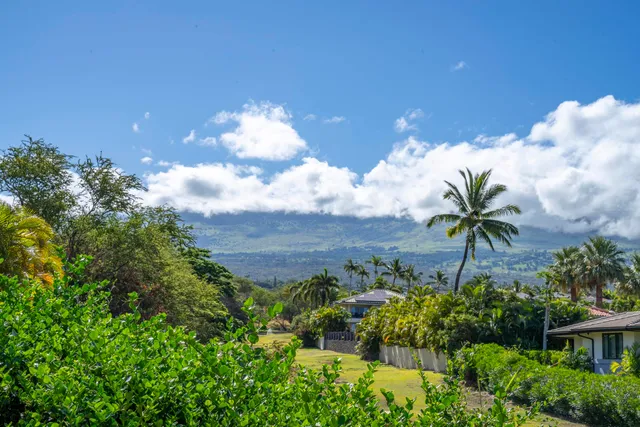 a living room with lots of furniture and a large window