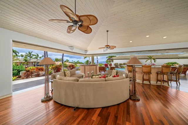 a dining room with furniture a chandelier and wooden floor