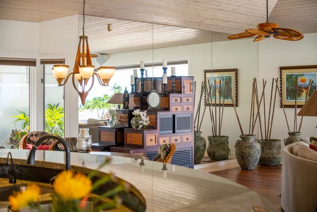 a bedroom with a bed a chandelier fan and a window