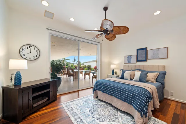 a bedroom with a bed and a painting on the wall