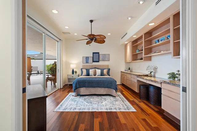 a bedroom with furniture and a large window