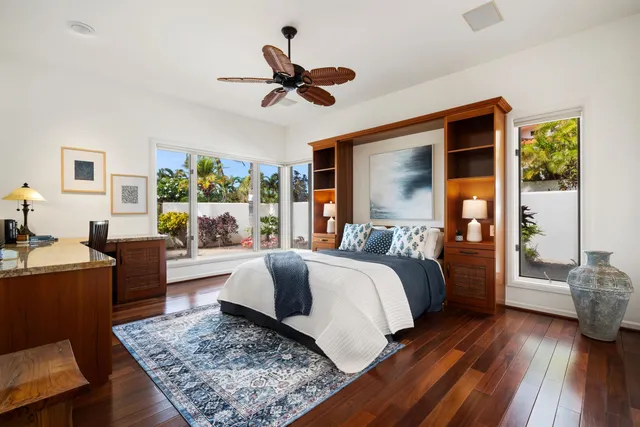 a bedroom with a large bed and a large window