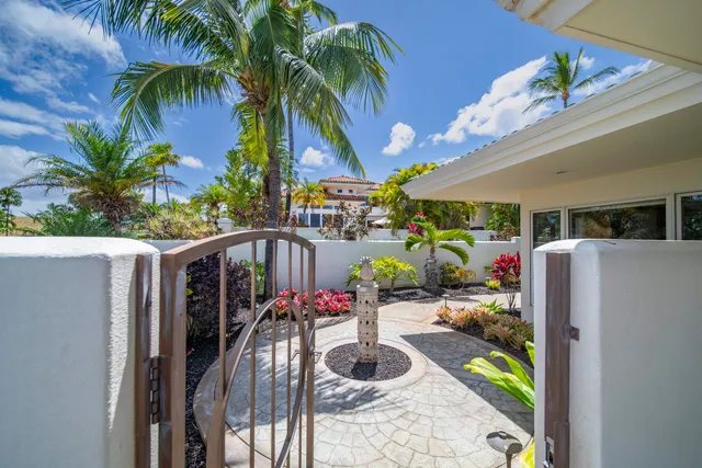 a vase with flowers sitting on a floor