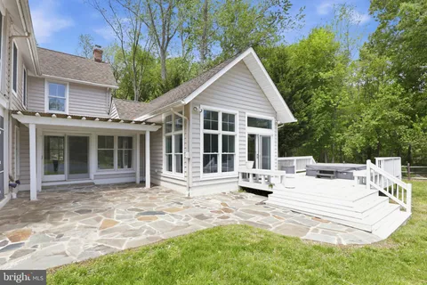 a view of a house with backyard sitting area and porch
