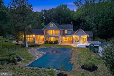 a front view of a house with yard and green space