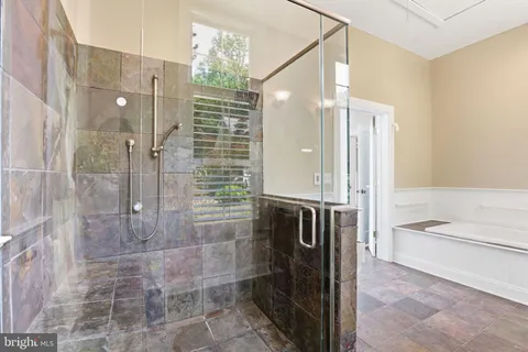 a bathroom with a bathtub and shower