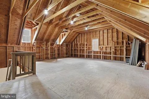 a view of an empty room with wooden stairs