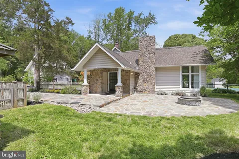 a front view of a house with a garden and yard