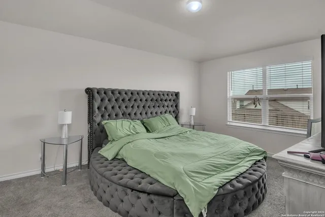 a bed sitting in a bedroom next to a window