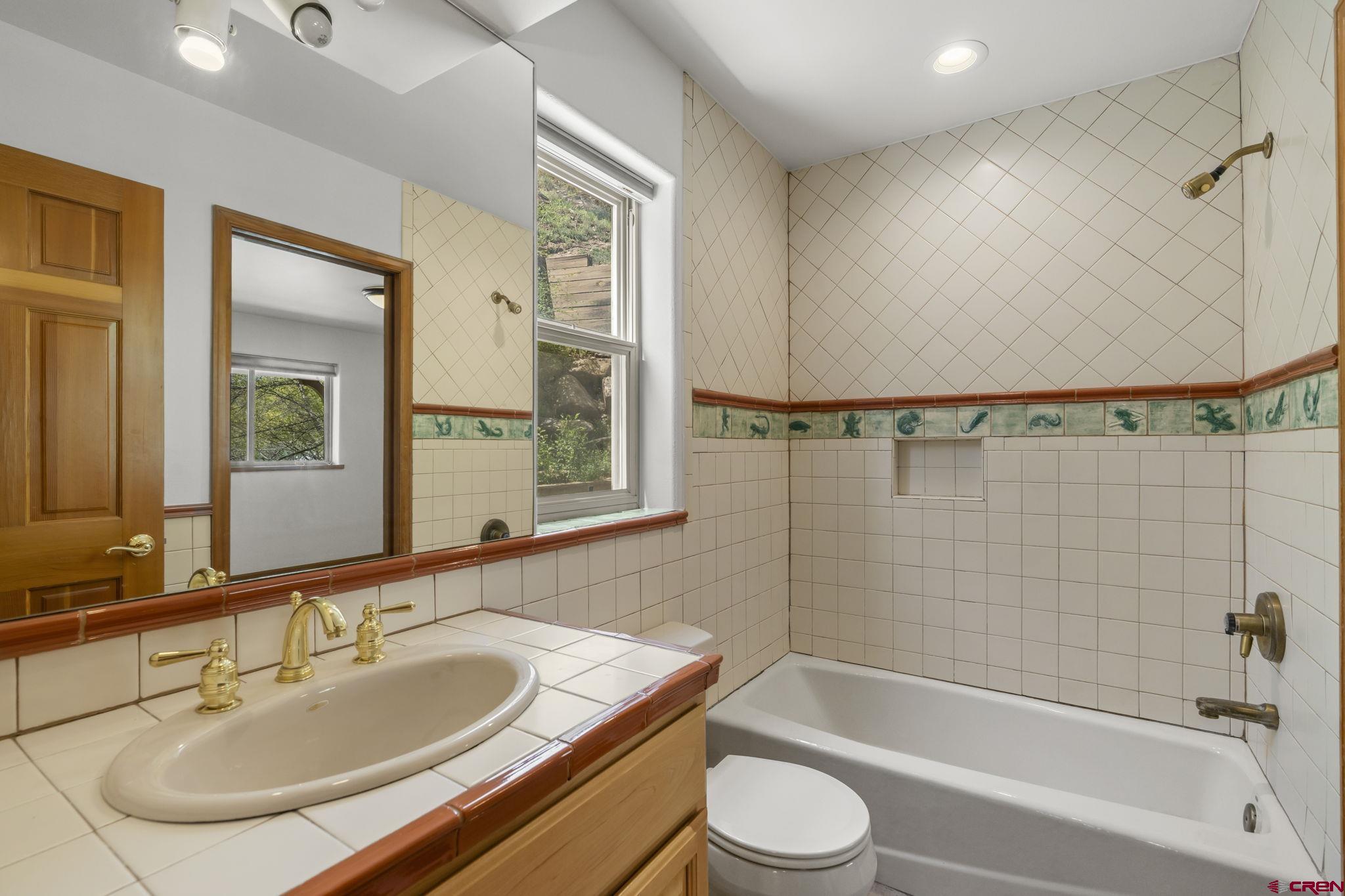 2015 West 3rd Avenue Durango, CO 81301 - Photo 19 of 32 a bathroom with a bathtub shower sink and a toilet