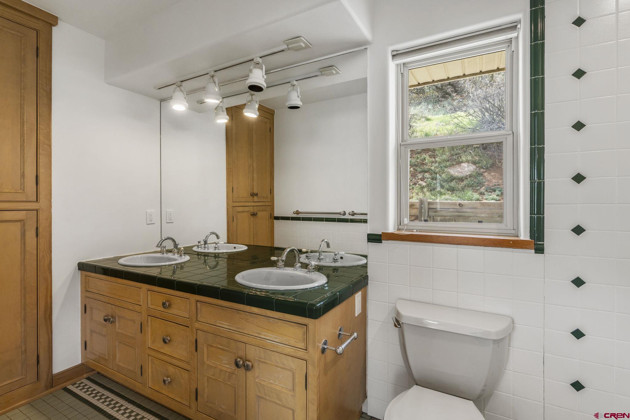 2015 West 3rd Avenue Durango, CO 81301 - Photo 26 of 32 a bathroom with a granite countertop sink toilet and a mirror