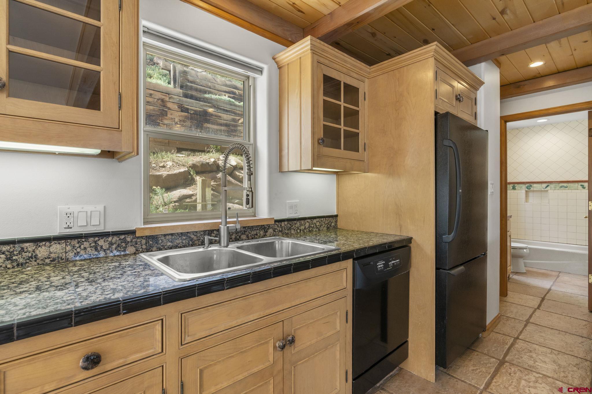 2015 West 3rd Avenue Durango, CO 81301 - Photo 7 of 32 a kitchen with granite countertop a sink and a refrigerator