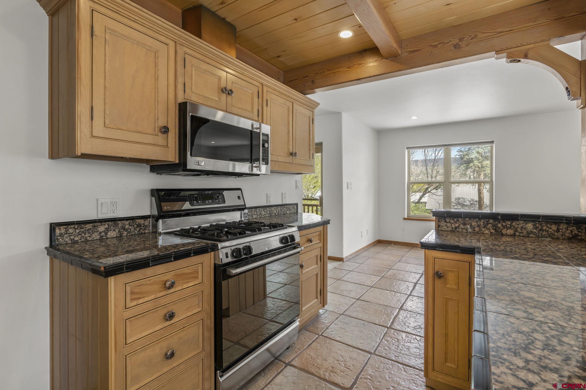 2015 West 3rd Avenue Durango, CO 81301 - Photo 8 of 32 a kitchen with stainless steel appliances granite countertop a stove a microwave and a sink