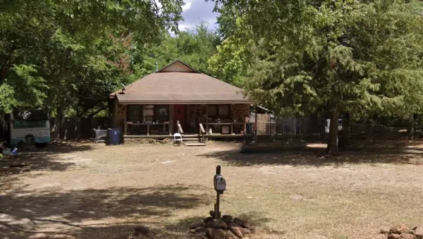 a patio with a table and chairs under an umbrella