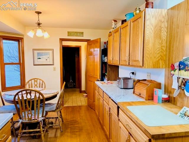 24988 Ben Kelly Road Elbert, CO 80106 - Photo 18 of 34 a kitchen that has a table chairs in it and wooden cabinets