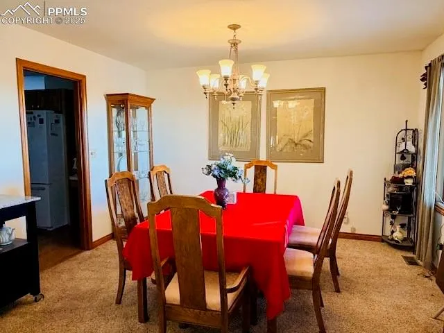 a living room with furniture a chandelier and a window