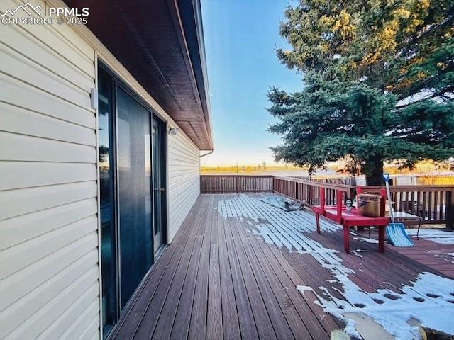 24988 Ben Kelly Road Elbert, CO 80106 - Photo 10 of 34 a balcony with chairs and wooden floor